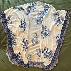 Cream duster with purple/blue floral accents. Fantastic to use as a beach cover!